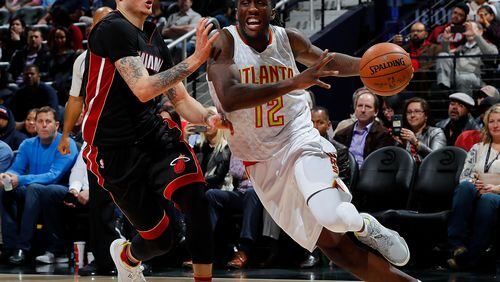 Taurean Prince of the Atlanta Hawks drives against Tyler Johnsonof the Miami Heat at Philips Arena on December 7, 2016 in Atlanta, Georgia. (Photo by Kevin C. Cox/Getty Images)