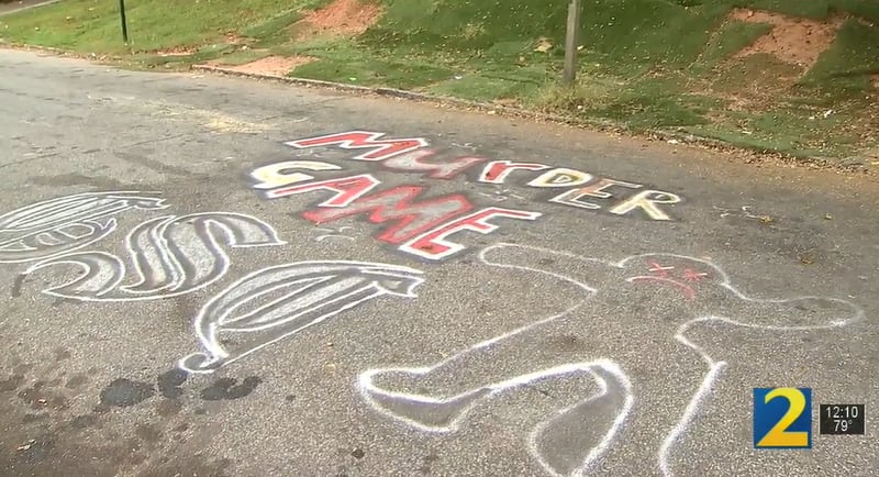 The words "murder game" were spray painted along with three letters and the cartoon outline of a body in the street outside a Beatie Avenue home where a man was killed Thursday morning.