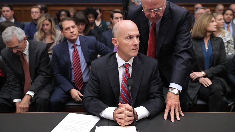 Former U.S. Sen. Saxby Chambliss, R-Ga., talks with ex-Equifax CEO Richard Smith before he testifies to a House Energy and Commerce Committee panel on October 3, 2017. (Photo by Chip Somodevilla/Getty Images)