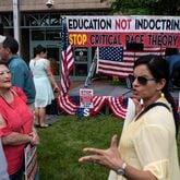 People talk before the start of a rally against critical race theory being taught in schools at the Loudoun County Government center in Leesburg, Virginia on June 12, 2021. (Andrew Caballero-Reynolds/AFP/Getty Images/TNS)