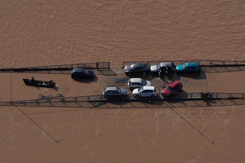 Cars sit on a submerged road in an area flooded by heavy rain in Porto Alegre, Rio Grande do Sul state, Brazil, Wednesday, May 8, 2024. (AP Photo/Andre Penner)