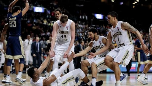 Georgia Tech guard Josh Okogie (5) is helped up by teammates after drawing a foul on a shot against Pittsburgh during the second half of an NCAA college basketball game in the first round of the ACC tournament, Tuesday, March 7, 2017, in New York. Pittsburgh won 61-59. (AP Photo/Julie Jacobson)