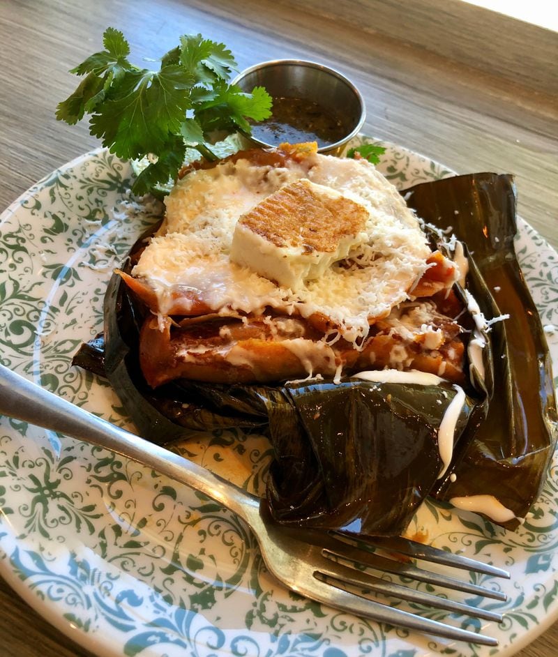 Chicken tamales from Botica are wrapped in banana leaves and steamed. 
Courtesy of Botica