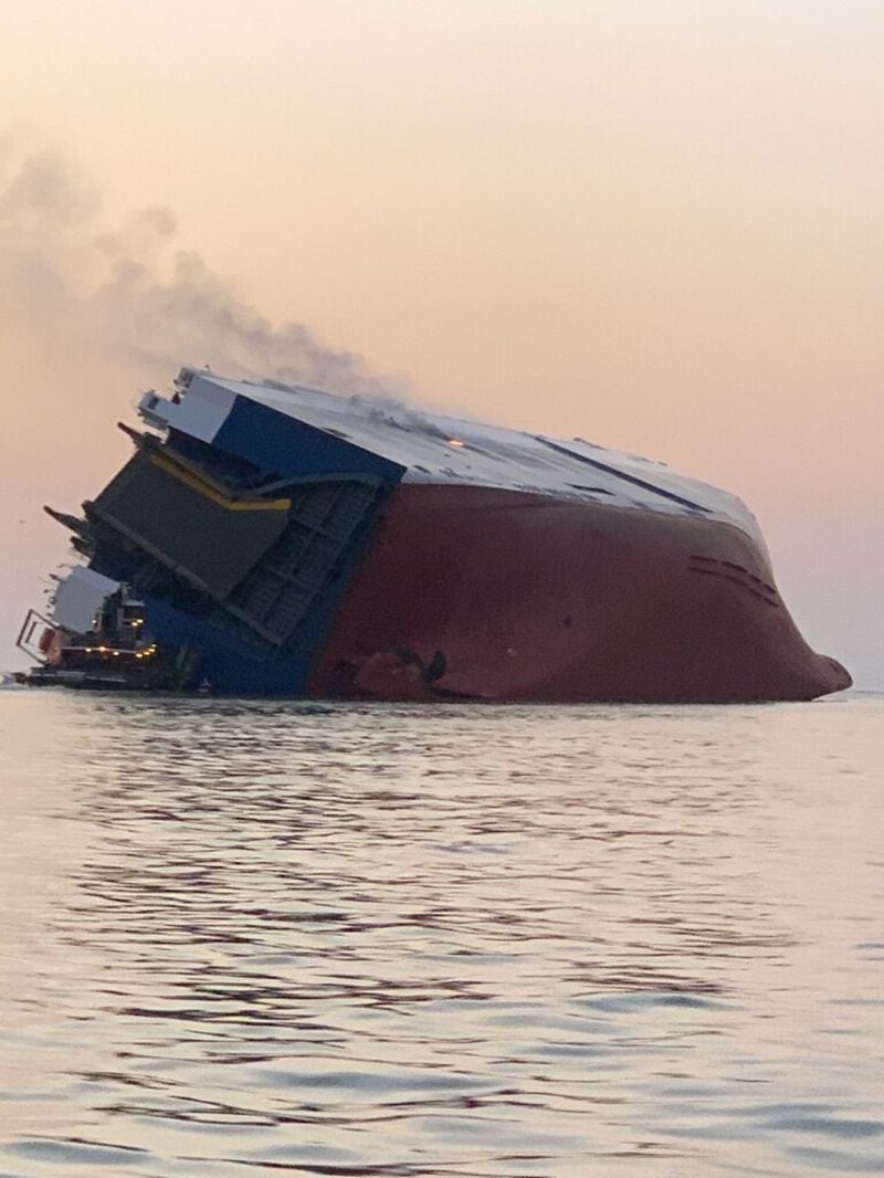 In this photo provided by the U.S. Coast Guard, the M/V  Golden Ray cargo ship is shown capsized near St. Simons Island, Georgia.