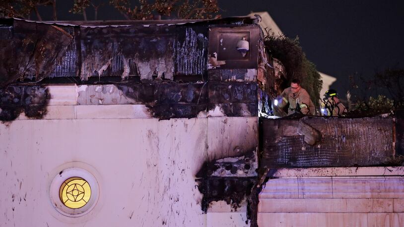 Firefighters inspect fire damage at the Bellagio hotel and casino along the Las Vegas Strip, Thursday, April 13, 2017, in Las Vegas. (AP Photo/John Locher)