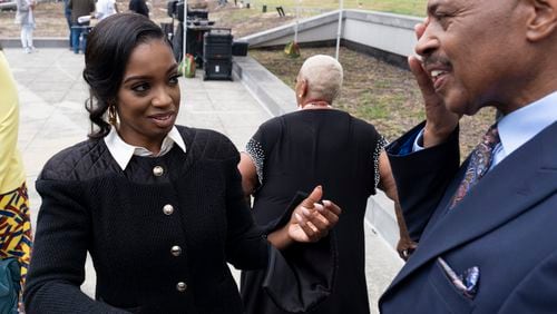 Fearless Fund CEO Arian Simone talks to her father Gregory Reed as he wipes away a tear after leave federal court in Atlanta on Tuesday, Sept. 26, 2023.   (Ben Gray / Ben@BenGray.com)