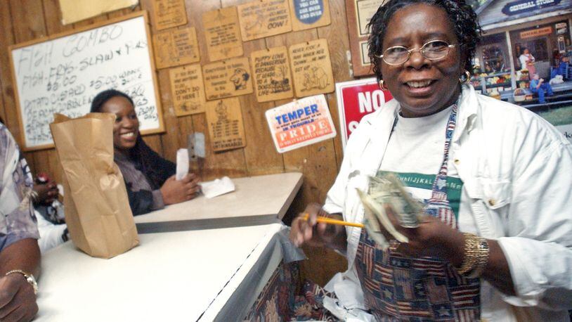 Frankie Rich, right, takes orders from customers at Bankhead Fish and Soul -- also known as Bankhead Seafood -- in 2006. / AJC file photo