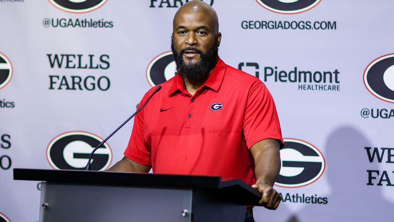 UGA running backs coach Dell McGee, here speaking to reporters at a news conference early in preseason camp, revealed Sunday that freshman Andrew Paul has been sidelined for the season with a knee injury. (Photo by Tony Walsh/UGA Athletics)