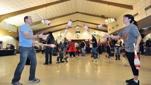 Neil Jordaan (left, cq) and Heather Marriott practice "passing pins" during the 36th Annual Groundhog Day Jugglers Festival at the Yaarab Shrine Center in Atlanta on Saturday, February 1, 2014. The festival sponsored by The Atlanta Jugglers Association featuring juggling competitions, workshops, unicycling, yo-yoing, hooping, a light extravaganza & a late night cabaret.