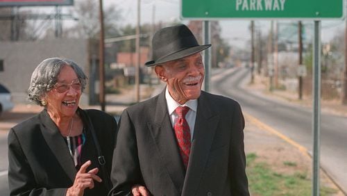 Louise Hollowell and her husband Donald Lee Hollowell standing at a road sign in Atlanta designating that Bankhead Highway had been renamed in Hollowell’s honor. Hollowell, an Atlanta attorney who died in 2004 at age 87, was a giant in the field of civil rights law. (Photo: Dec. 3, 1998)