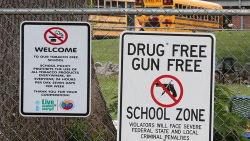 Signs hang on the fence around the Taliaferro County school complex on Wednesday, May 23, 2018, in Crawfordville. Taliaferro County is the state’s smallest school district. Curtis Compton/ccompton@ajc.com