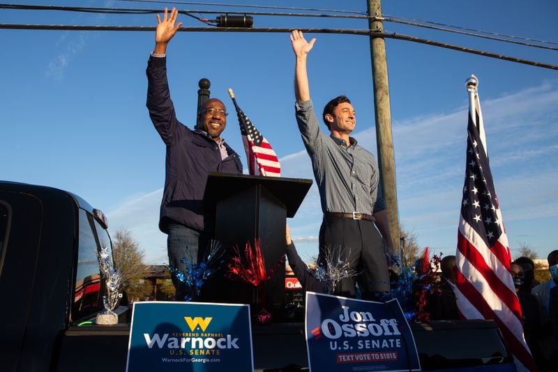 Democratic U.S. Senate candidates Jon Ossoff (R) and Raphael Warnock (L) of Georgia wave to supporters during a rally on November 15, 2020 in Marietta, Georgia. Ossoff and Warnock face incumbent U.S. Sens. David Purdue (R-GA) and Kelly Loeffler (R-GA) respectively in a runoff election January 5, 2021.  (Jessica McGowan/Getty Images/TNS)
