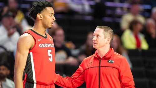 Georgia head coach Mike White, right, speaks with center Frank Anselem (5) in the first half of an NCAA college basketball game against Wake Forest, Friday, Nov. 11, 2022, in Winston-Salem, N.C. (Allison Lee Isley/The Winston-Salem Journal via AP)