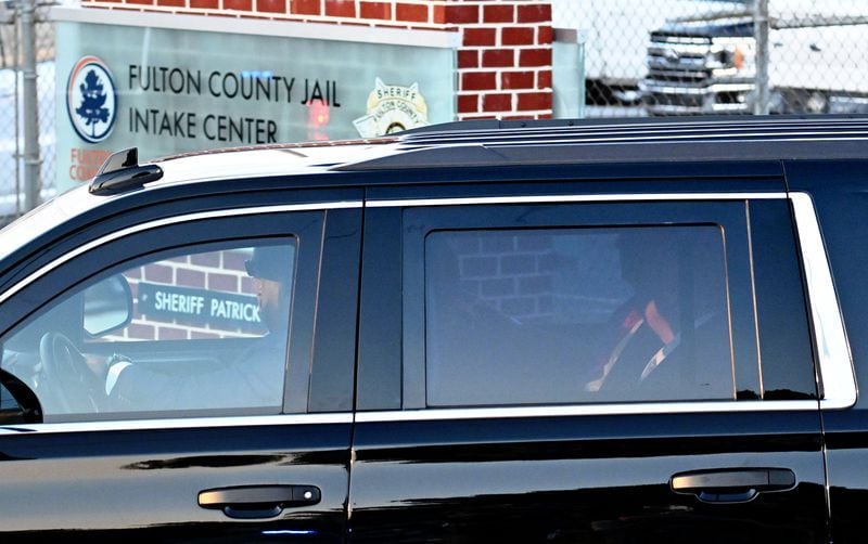 Former President Donald Trump enters the Fulton County Jail, Thursday, August 24, 2023, in Atlanta. (Hyosub Shin / Hyosub.Shin@ajc.com)