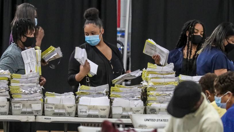 August 11, 2020 Atlanta: Some 70 Fulton County Registration & Election Board workers handled about 20,000 absentee ballots on Tuesday, August 11, 2020 at State Farm Arena located at 1 State Farm Drive in Atlanta. JOHN SPINK/JSPINK@AJC.COM