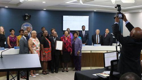 Council members and congregation members pose for a photo with Rev. P. L. Redmond, Jr., after he was honored with a proclamation presented by Council member Joyce Sheperd in August. BOB ANDRES /BANDRES@AJC.COM