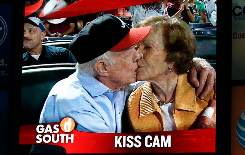 President Jimmy Carter kisses his wife Rosalynn on the "Kiss Cam" during Braves game at Turner Field in 2015. (AP Photo/John Bazemore)