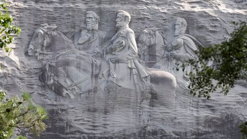 This June 23, 2015, file photo shows a carving depicting confederates Stonewall Jackson, Robert E. Lee and Jefferson Davis, in Stone Mountain, Georgia.