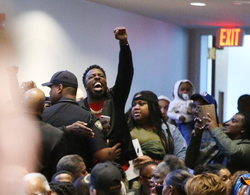 People protest the way the death of 21-year-old Jimmy Atchison was handled by officials at a town hall hosted by Atlanta Mayor Keisha Lance Bottoms at Cascade United Methodist Church in Atlanta, Georgia on Tuesday, March 19, 2019. EMILY HANEY / AJC file photo