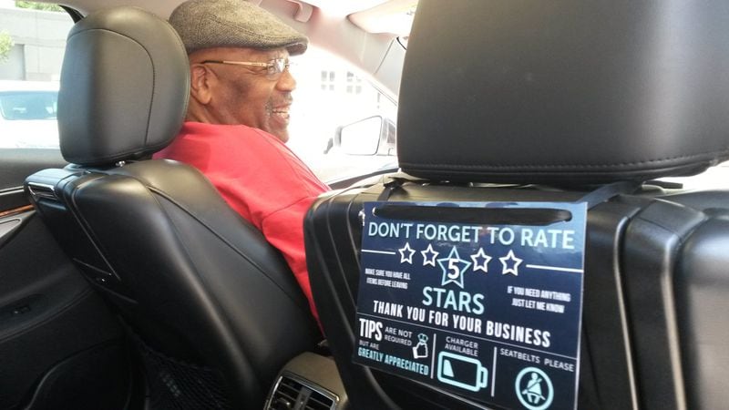 Uber drivers are likely to see more tips from passengers now that the ride-hailing company is changing its app to include the option to give a gratuity. Samuel Howard, an Uber driver from Norcross, already uses a sign to encourage giving. MATT KEMPNER / AJC