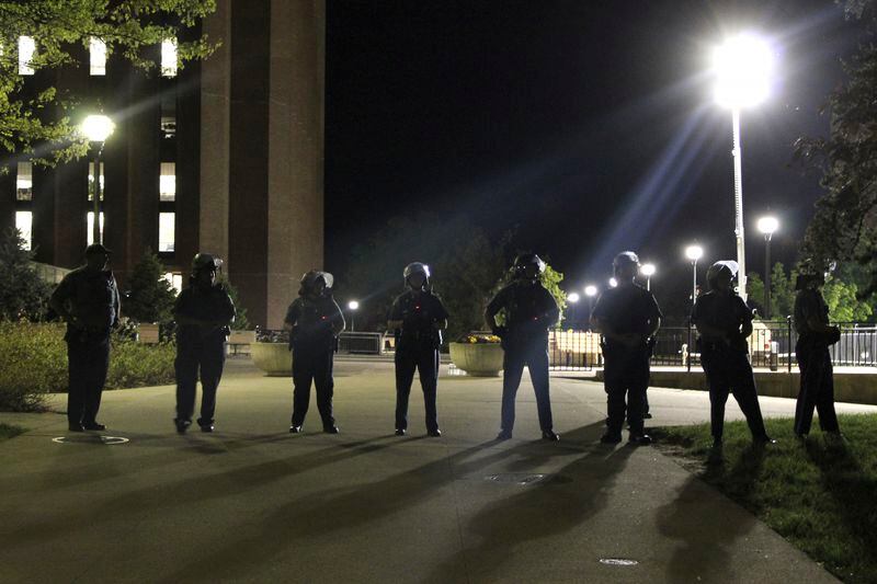 Members of law enforcement form a line Wednesday, May 8, 2024, on the University of Massachusetts Amherst campus, in Amherst, Mass. Police moved in Tuesday night to break up an encampment at the school in what appeared in video to be an hours-long operation as dozens of police officers in riot gear systematically tore down tents and took protesters into custody. The protesters established the tent encampment to demonstrate against the war in Gaza. (Kalinka Kornacki via AP)