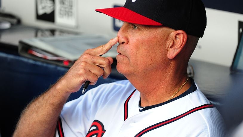 Braves interim manager Brian Snitker goes over signals before Tuesday's game against Milwaukee at Turner Field. It was Snitker's first home game since taking over for Fredi Gonzalez. (Scott Cunningham / Getty Images)