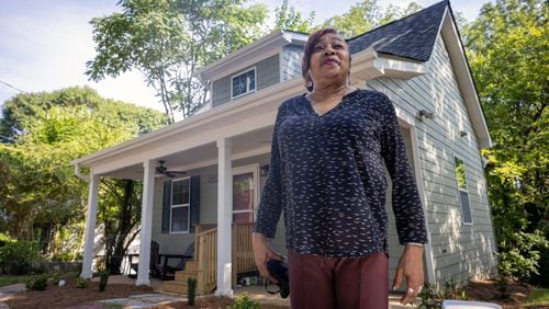 Deborah Glover stands in front of the new home that she will share with young women and children in need of temporary housing. (Steve Schaefer / steve.schaefer@ajc.com)