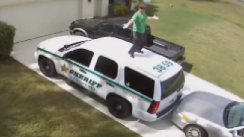 Florida man dances on patrol car to protect children from...