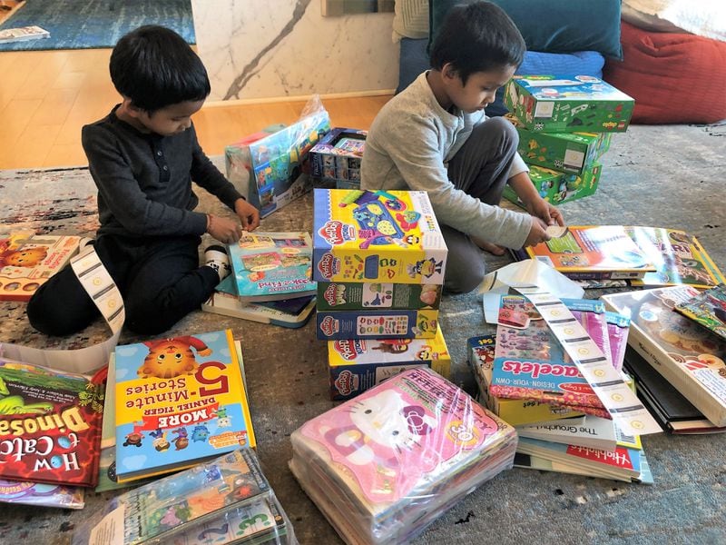 Twin brothers, Arjun (L) and Akshay are shown packing toys, games and books that the foundation donated to kids at CHOA on Yuvi’s birthday this year, March 12.