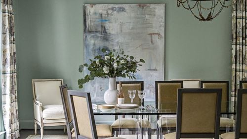 Bosbyshell designed this traditional-with-a-twist dining room, located in the Argonne Forrest neighborhood in Buckhead, for a young family of seven. The Lucite table is mixed with traditional chairs and an Oushak rug. Contributed by Heidi Gelhauser