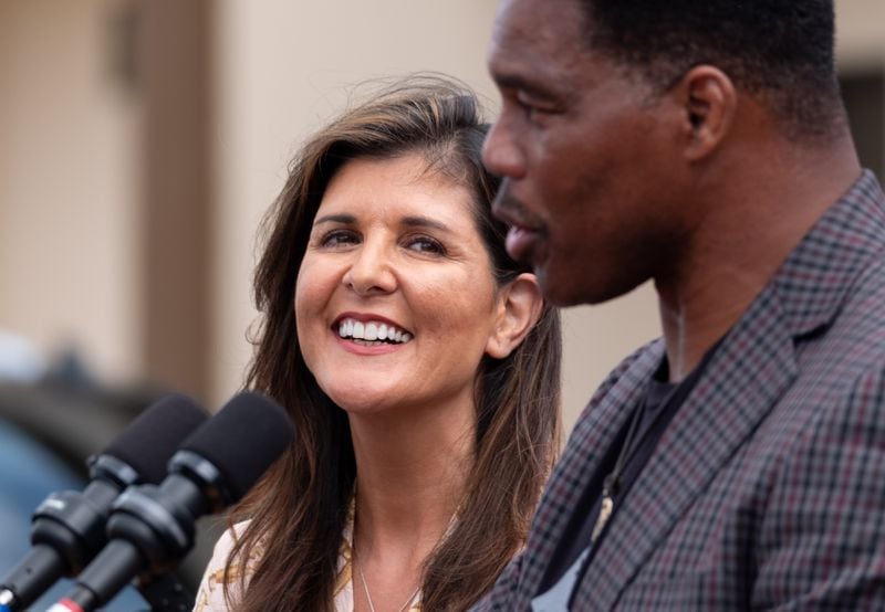 Nikki Haley smiles at Republican Senate candidate Herschel Walker during a campaign stop in Norcross on Friday, Sept. 9, 2022. (Ben Gray for the Atlanta Journal-Constitution)