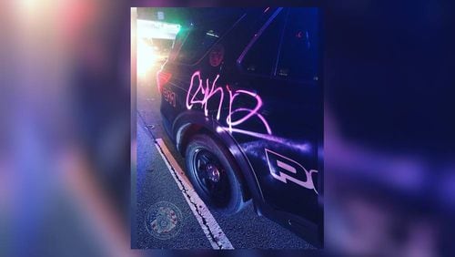 Police say six patrol cars were vandalized Saturday.