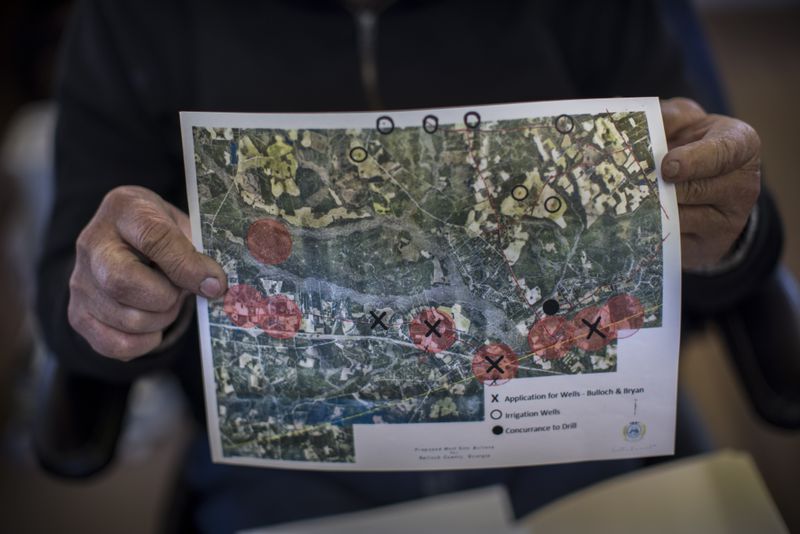 Bulloch County farmer Ray Davis holds a map of well sites on Wednesday, Feb. 21, 2024 near Brooklet, Ga. (AJC Photo/Stephen B. Morton)