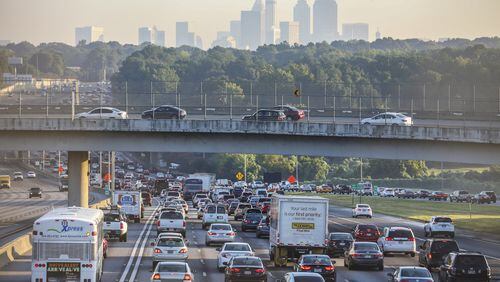 The Atlanta skyline loomed overhead as northbound traffic crawls along the Downtown Connector past Arthur B. Langford Parkway in August 2016. JOHN SPINK /JSPINK@AJC.COM