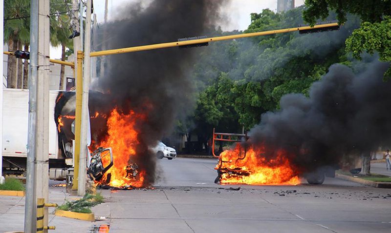 Vehicles burn in a street of Culiacan, state of Sinaloa, Mexico, on Oct. 17 after government forces tried to arrest one of convicted drug trafficker El Chapo’s sons.