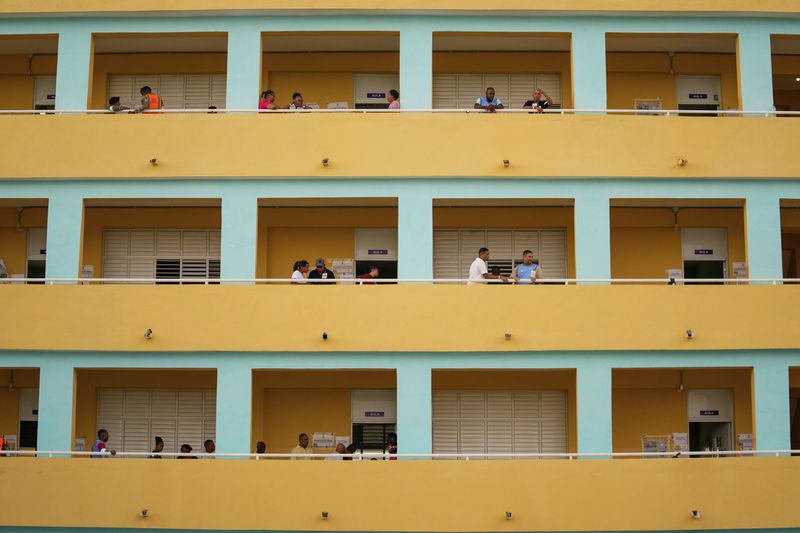 Voters gather at a school serving as a polling station during the general elections in Santo Domingo, Dominican Republic, Sunday, May 19, 2024. (AP Photo/Matias Delacroix)