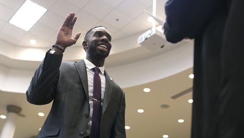 12-20-18 - Suwanee, GA - Everton Blair takes an oath during his swearing in ceremony at the Gwinnett County Board of Education office in Suwanee, Ga., on Thursday, Dec. 20, 2018. Blair will be the first black member of the Gwinnett County Board of Education, as well as the youngest. (Casey Sykes for The Atlanta Journal-Constitution)