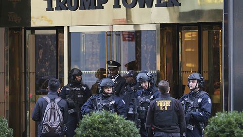 In this Nov. 17, 2016 file photo, New York City Police Department officers stand at the front entrance of Trump Tower in New York. The new federal spending bill would allocate $61 million to reimburse primarily New York City and Palm Beach County for police overtime and other local expenses related to securing President Donald Trump and his family at Trump Tower and Mar-a-Lago.