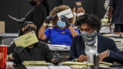 The counting of absentee ballots is among the many issues that could spark legal action concerning Tuesday's election. JOHN SPINK/JSPINK@AJC.COM
