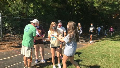 Students at Crews Middle School have their participation forms checked off during a recent 3-mile walk to promote inclusiveness.