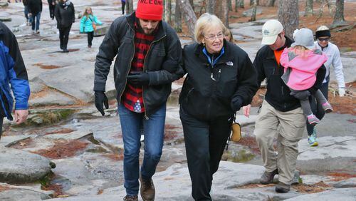 WALKING THE MOUNTAIN--Dec. 31, 2013 - Stone Mountain - Benito Ferro (left) and Margie Bowen walk together on the hike. Ferro is Bowen's daughter's boyfriend. On Tuesday morning, 63-year-old Margie Bowen hiked up Stone Mountain for the 500th time (all since mid-2010). Her daughter and her daughter's boyfriend wanted to mark the occasion on Instagram, by creating an "instawalk". Bowen's friends and former students will joined her on the walk and documented the climb on Instagram with dozens of photos. BOB ANDRES / BANDRES@AJC.COM