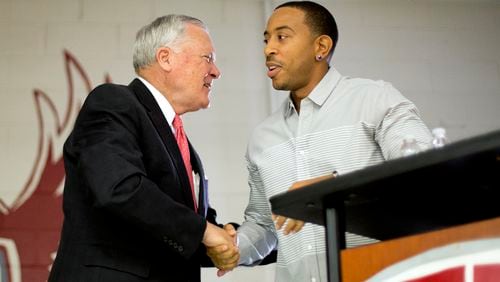 Rapper Ludacris, right, shakes hands with Georgia Gov. Nathan Deal while visiting the charter school Utopian Academy for the Arts, Friday, Sept. 26, 2014, in Riverdale, Ga. Deal and Ludacris may seem like an odd pairing for a campaign event, but the duo was a hit with a cheering crowd of students Friday. Christopher "Ludacris" Bridges has been an outspoken supporter of President Barack Obama, penning a profane song during the 2008 campaign criticizing his opponents. But Deal says he couldn't think of anyone better to inspire students at the event. (AP Photo/David Goldman)