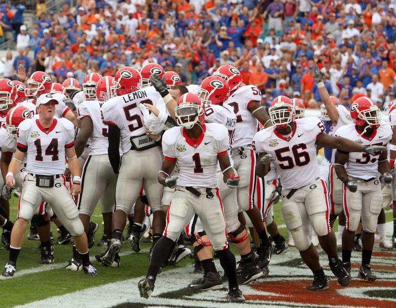 Georgia wide receiver Mohamed Massaquoi (1) celebrates with his entire team after the game's first touchdown. (JASON GETZ  / Staff)
