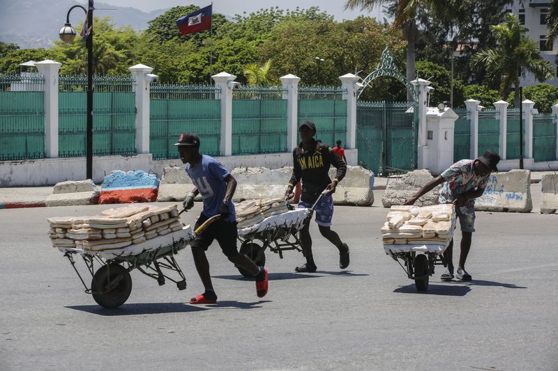 FILE - Street vendors withdraw from the area where they were selling their bread, near the National Palace, in Port-au-Prince, Haiti, April 2, 2024. (AP Photo/Odelyn Joseph, File)