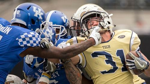 Georgia Tech running back Nate Cottrell, right, is tackled by Kentucky cornerback J.D. Harmon (11) on a kick return during the second half of the TaxSlayer Bowl NCAA college football game, Saturday, Dec. 31, 2016, in Jacksonville, Fla. Georgia Tech beat Kentucky 33-18. (AP Photo/Stephen B. Morton)