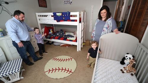 031521 Cartersville: Melanie and Kris Lambert and their sons Connor, 5, and Harrison, 2, prepare the boy’s room for the birth of their third son Hank, who will be taking over Harrison’s crib while he moves to the bunk beds at the family home on Monday, March 15, 2021, in Cartersville. Curtis Compton / Curtis.Compton@ajc.com