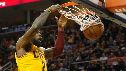 LeBron James of the Cleveland Cavaliers dunks against the Brooklyn Nets during the second quarter at Quicken Loans Arena in Cleveland on Thursday, March 31, 2016. (Karen Schiely/Akron Beacon Journal/TNS)