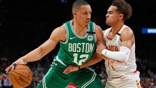 Celtics forward Grant Williams (12) drives to the basket against Hawks guard Trae Young on Monday, Feb. 3, 2020, in Atlanta. (AP Photo/Todd Kirkland)