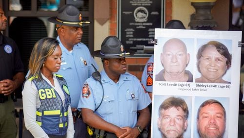 Multiple law enforcement agencies gathered outside of the Hampton Police Department to give an update on the mass shooting and the suspect on Sunday. Photos of the slain victims were shared. (Ben Hendren for The Atlanta Journal-Constitution)