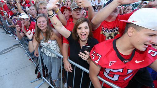 October 28, 2017 Jacksonville: Fans cheers their team as Georgia arrives at EverBank Field during the Dawg Walk for the Georgia-Florida game on Friday, October 27, 2017, in Jacksonville. Curtis Compton/ccompton@ajc.com